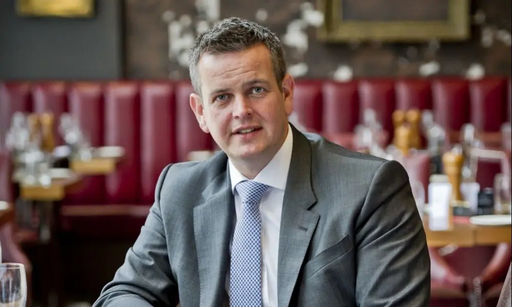 Macdonald group reduces debt by £100m